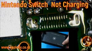 Nintendo Switch not charging repair showing a damaged USB-C charging port on the motherboard before replacement. Featured image highlights professional Nintendo Switch charging port repair, USB-C connector replacement, Nintendo Switch turns on but won't charge diagnosis, microsoldering, motherboard repair, and console repair services by AppleFix & Tech Engineers in Hamilton, Waikato, New Zealand.