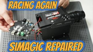 **Alt Text:** **Professional Simagic wheel base repair showing the motherboard removed during USB port replacement and microsoldering repair. Expert racing simulator hardware repair for Simagic direct drive wheel bases, including motherboard diagnostics, USB connector replacement, and component-level repairs by AppleFix & Tech Engineers in Hamilton, New Zealand.**